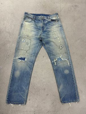 Light Wash Denim Bottom With Heavy Distressing For A Rugged Vintage Look