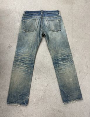 Light Wash Jeans With Heavy Fading And Whiskering For A Rugged Vintage Look
