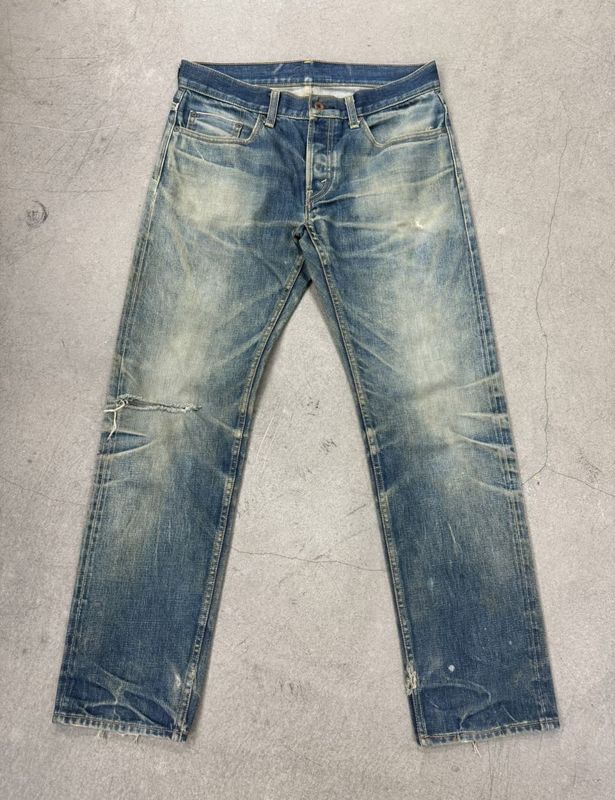 Light Wash Jeans With Heavy Fading And Whiskering For A Rugged Vintage Look